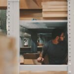 man under a bunch of large shelves